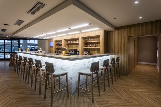 The W Lounge Belém bar at Val de Cans Airport offers counter seating with a variety of wines and spirits displayed.