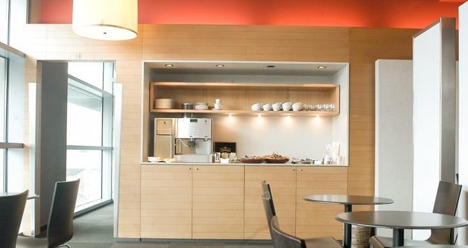 The Dan Lounge at Ben Gurion Airport features a self-serve coffee station with cups, glasses, and a selection of snacks.