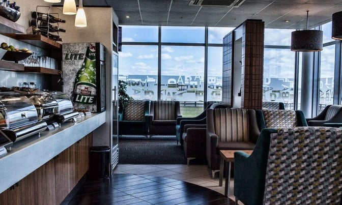The Bidvest Premier Lounge at East London Airport features a self-serve food area and comfortable seating with airport views.