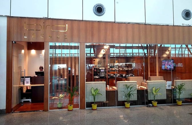 The Bird Lounge entrance at Biju Patnaik International Airport features a reception desk and visible seating area with potted plants.