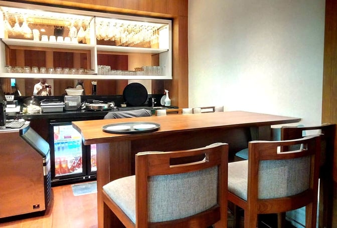 The Bird Lounge at Biju Patnaik International Airport features a bar area with counter seating and a selection of glassware.