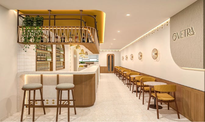 The O'Vetra Domestic Lounge at Biju Patnaik International Airport features a bar area with counter seating and a row of tables.