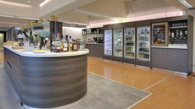 The Nervión VIP Lounge at Bilbao Airport features a self-serve bar with a selection of spirits and refrigerated beverages.
