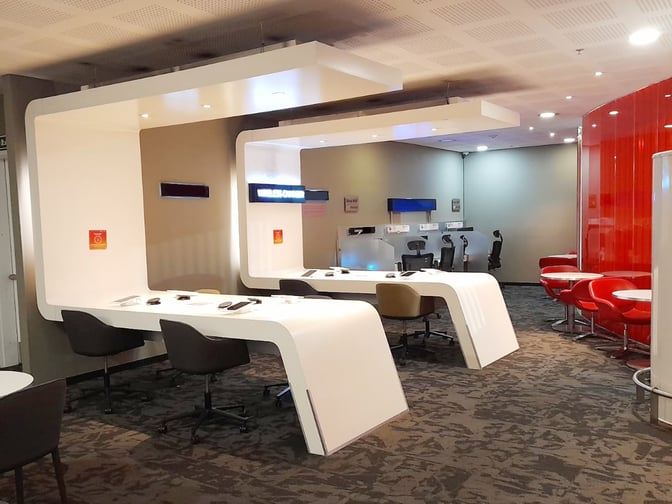 The Avianca Bogota Gold Lounge features workstations with charging ports and seating, providing a space for travelers to work or relax.