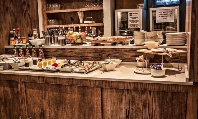 Self-serve food station at Bidvest Premier Lounge, Bram Fischer International Airport, offers a variety of snacks, condiments, and beverages.