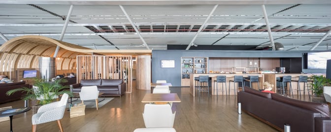 The VIP Express Club Pier Norte at Brasilia International Airport features a seating area with tables and a bar offering refreshments.