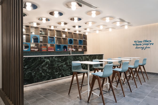 The Essence Lounge bar at Bristol Airport features high-top seating and a selection of beverages.