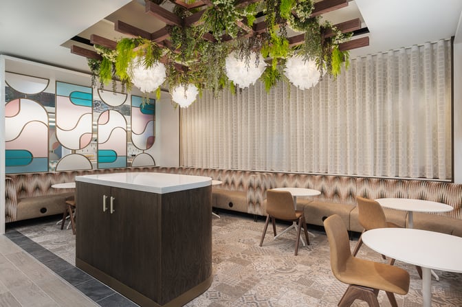 Booth seating in the Essence Lounge at Bristol Airport offers semi-private dining with small tables.