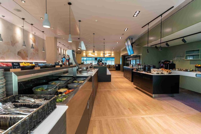 The Diamond Lounge at Brussels Airport features a self-serve food area with a variety of salads, snacks, and beverages.