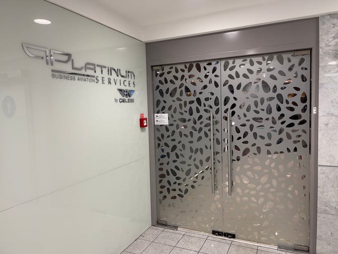 The entrance to the Platinum Lounge at Budapest Airport features decorative glass doors and signage for Platinum Business Aviation Services.