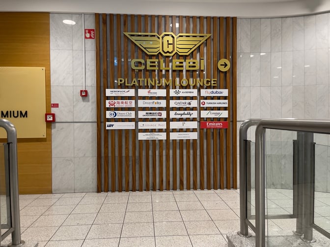 The entrance to the Platinum Lounge at Budapest Airport features airline partner logos and directional signage near a staircase.