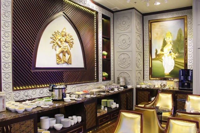 The Champ Lounge at Cam Ranh International Airport features a buffet area with self-serve dishes and a coffee machine.