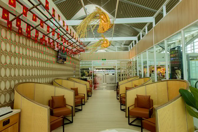 Semi-private seating in the SH Premium Lounge at Cam Ranh International Airport offers individual chairs with partitioned enclosures for privacy.