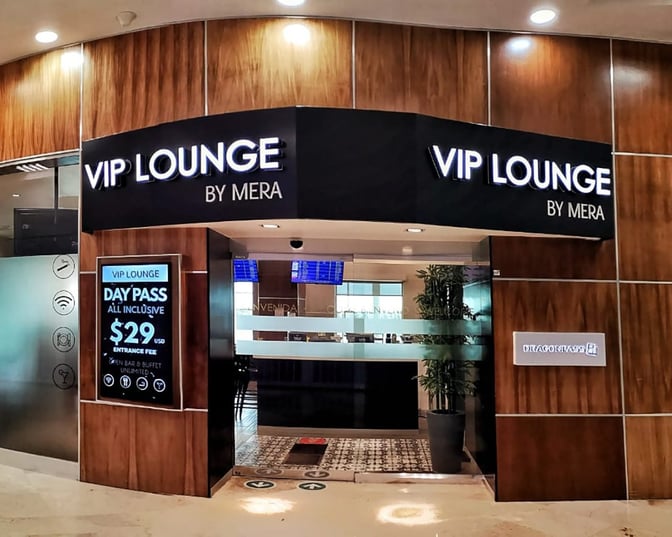 The entrance to the VIP Lounge by Mera at Cancun International Airport features signage for day pass pricing and amenities.
