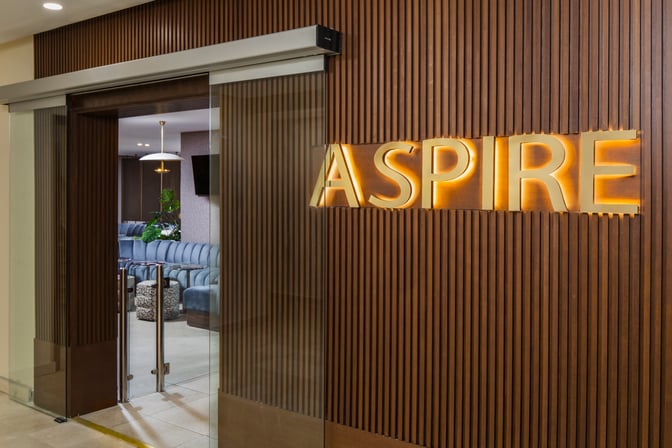 The entrance to the Casablanca Aspire Lounge Terminal 2 features sliding glass doors and a visible seating area inside.