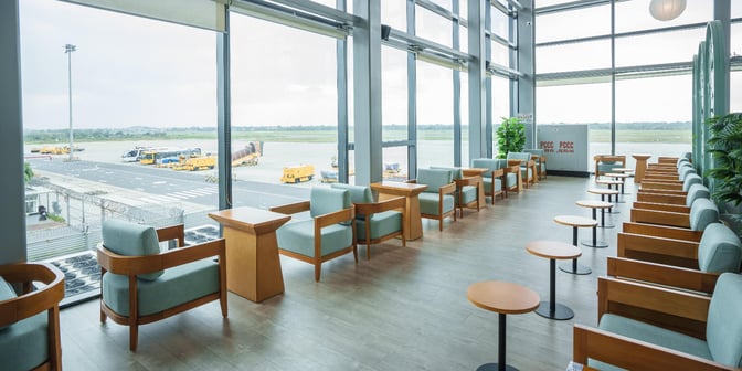 The seating area in SH Premium Lounge at Cat Bi International Airport offers comfortable chairs with views of the airport runway.