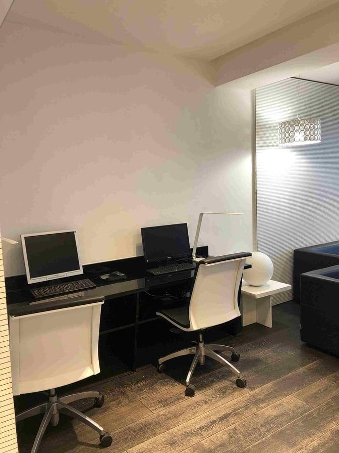 The Angelo D'Arrigo VIP Lounge at Catania–Fontanarossa Airport features a work area with computers and chairs for passenger use.