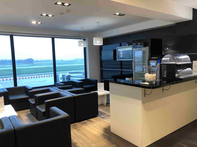 The Angelo D'Arrigo VIP Lounge at Catania–Fontanarossa Airport features a seating area with armchairs and a counter with refreshments.
