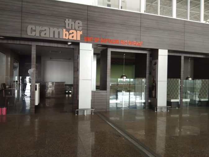 The entrance to The Cram Bar at Chandigarh Airport's Domestic-T1 features a reception area and visible seating booths inside.