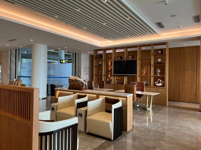 The First Class VIP Room No. 18 at Changsha Huanghua International Airport features seating areas with tables and a display shelf.