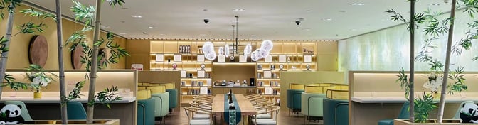 The China Eastern Lounge at Chengdu Tianfu International Airport features booth seating, a communal table, and a bookshelf for passenger use.