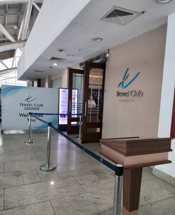 The entrance to the Travel Club Lounge at Chennai International Airport features a welcome sign and a reception podium.