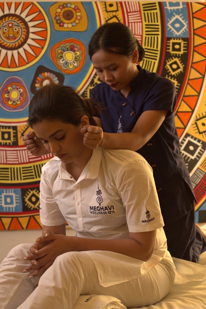 A therapist at Meghavi Air SpaLounge near Gate 49 provides a seated massage service at Chhatrapati Shivaji International Airport.