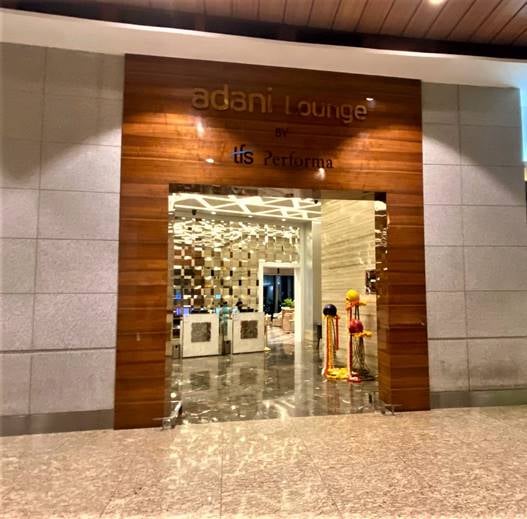 The entrance to the Adani Lounge at Chhatrapati Shivaji International Airport features a wide doorway with visible interior seating and decor.