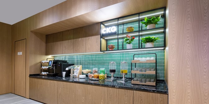 The Plaza Premium Lounge at Chongqing Jiangbei International Airport features a self-serve snack and beverage station with dispensers and glassware.