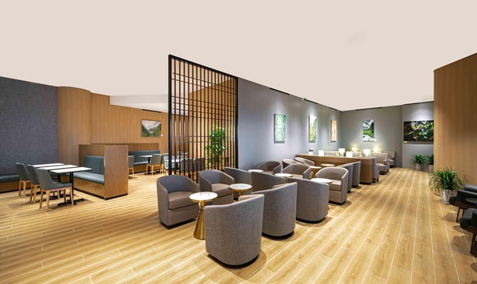 The Plaza Premium Lounge at Chongqing Jiangbei International Airport features comfortable seating areas with tables and semi-private booths for travelers.