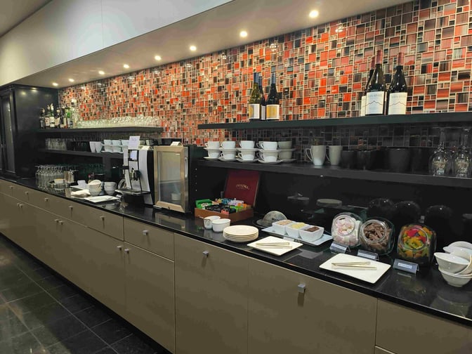 The Manaia Lounge at Christchurch International Airport features a self-serve area with beverages, snacks, and tableware for guests.