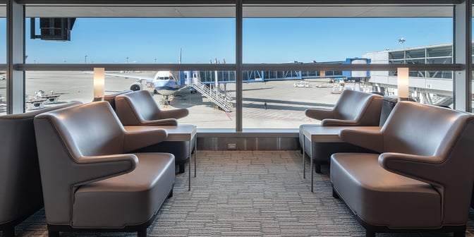 Seating area in the Plaza Premium Lounge at Chubu Centrair International Airport offers views of the tarmac and boarding gates.