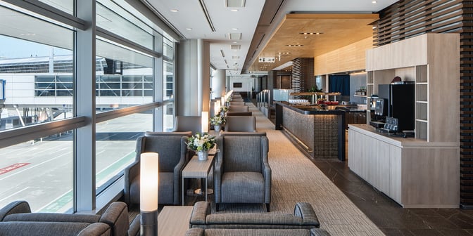 The Plaza Premium Lounge at Chubu Centrair International Airport features comfortable seating with runway views and a self-serve beverage station.