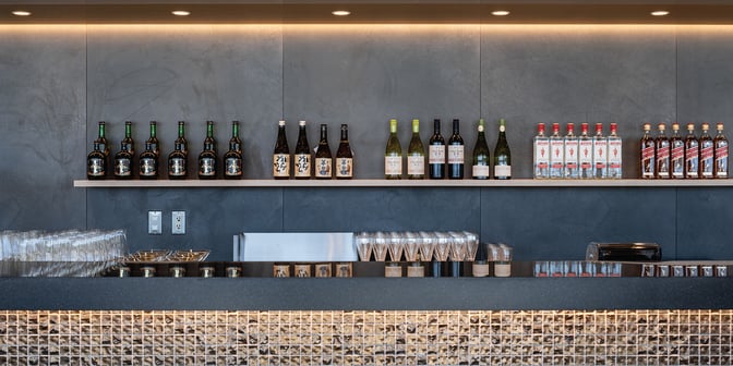 The bar at Plaza Premium Lounge in Chubu Centrair International Airport offers a selection of spirits and glassware for guests.
