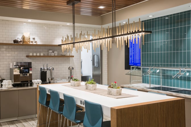 The Escape Lounge at Cincinnati/Northern Kentucky International Airport features a self-serve beverage station with coffee machines and seating.