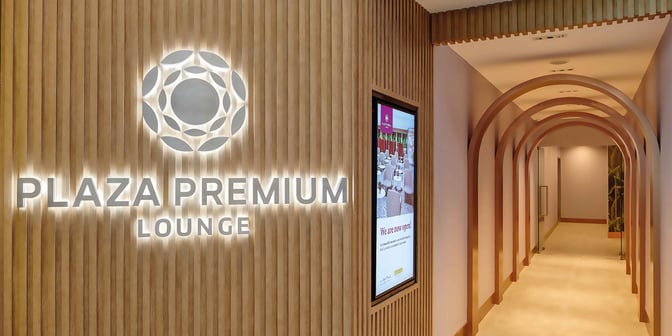 The entrance to the Plaza Premium Lounge at Clark International Airport features a sign and a hallway with archways.