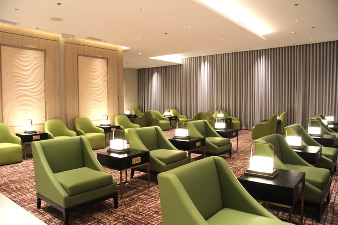 The seating area in Marhaba Lounge at Clark International Airport features individual chairs with side tables and personal lamps.