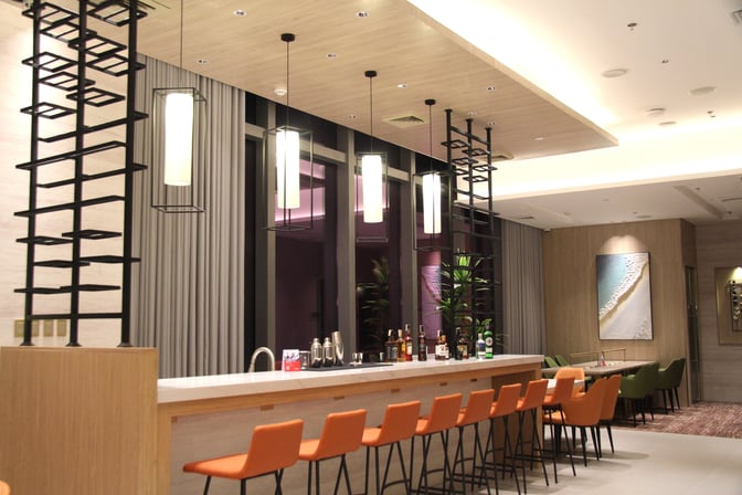 The Marhaba Lounge at Clark International Airport features a bar area with counter seating and a selection of spirits and beverages.