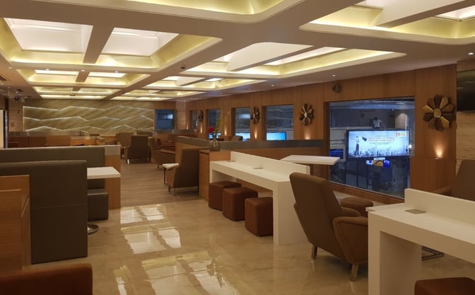 The BlackBerry Lounge at Coimbatore International Airport features a spacious seating area with tables and chairs for travelers.
