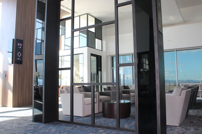 The seating area in the VIP Lounge at Comayagua International Airport features comfortable chairs and a central table with expansive window views.