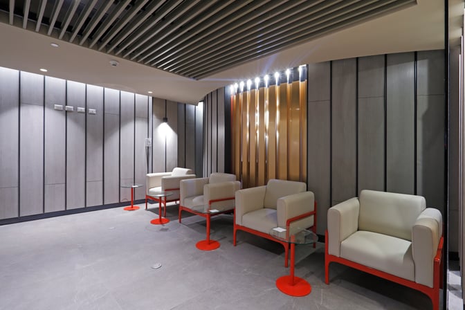 The Andes Lounge at Comodoro Arturo Merino Benítez International Airport features a seating area with armchairs and small side tables.