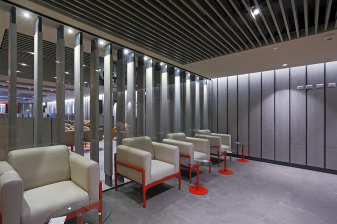 The Andes Lounge at Comodoro Arturo Merino Benítez International Airport features a seating area with armchairs and small side tables.