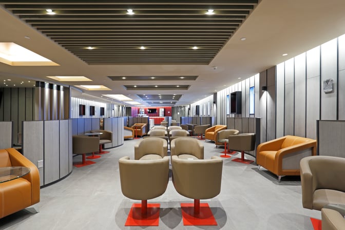 The Andes Lounge at Comodoro Arturo Merino Benítez International Airport features spacious seating areas with individual chairs and small tables.