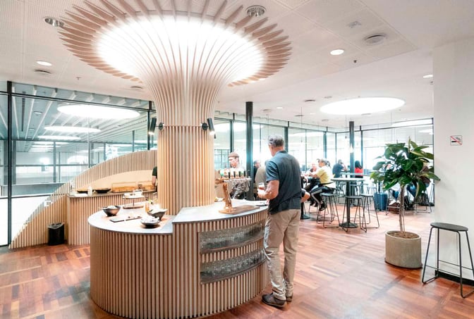 The Carlsberg Aviator Lounge at Copenhagen Airport features a central bar area with self-serve taps and seating for guests.