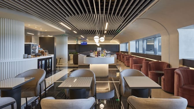 The Goldair Handling Lounge at Ioannis Kapodistrias International Airport features a central bar area with seating and self-serve beverage options.