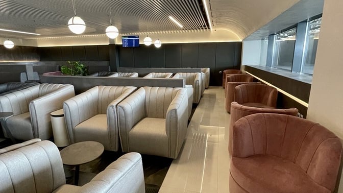 The Goldair Handling Lounge at Ioannis Kapodistrias International Airport features comfortable seating with armchairs and small tables for travelers.