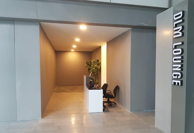 The entrance to the DLM Lounge at Dalaman Airport features a reception desk and seating area for guest check-in.