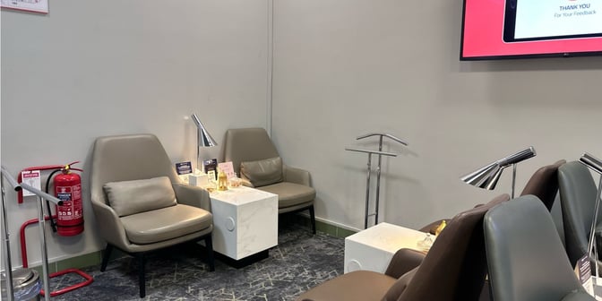 Seating area in Hayyak Lounge at Dawadmi Domestic Airport features comfortable chairs, side tables with lamps, and a fire extinguisher nearby.