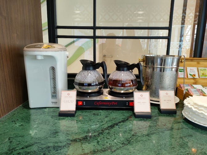 The SH Premium Lounge at Dien Bien Phu Airport offers a self-serve beverage station with hot water, coffee, and tea options.
