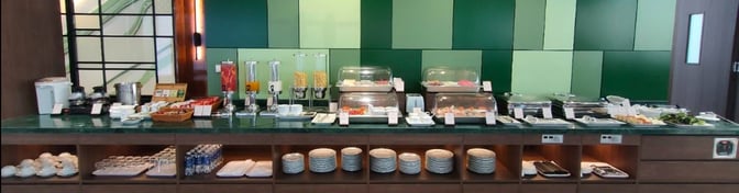 The SH Premium Lounge at Dien Bien Phu Airport features a self-serve food station with beverages, snacks, and dining essentials.